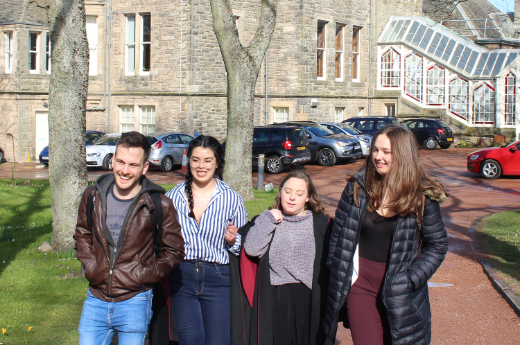 a group of students outside the School of Economics